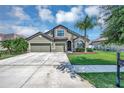 Charming two-story home with a well-manicured lawn, mature trees and a 3-car garage at 6722 Wild Elm Ct, Wesley Chapel, FL 33545