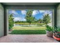 Brick patio overlooking a tranquil lake view at 6722 Wild Elm Ct, Wesley Chapel, FL 33545