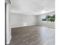 Spacious living area featuring hardwood floors and ample natural light at 1019 Deer Run, Venice, FL 34293