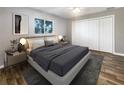 Main bedroom with large closet and wood-look floors at 1019 Deer Run, Venice, FL 34293