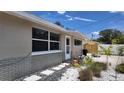 Updated house exterior, featuring a landscaped walkway and newly painted siding at 1620 Lakeview Pl, Englewood, FL 34223