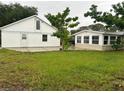 Spacious backyard with detached garage and additional structure at 1620 Lakeview Pl, Englewood, FL 34223