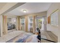 Bright home office features a desk, sliding glass doors to a bedroom, and ample natural light at 1433 S Belcher Rd # C1, Clearwater, FL 33764