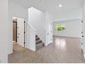Foyer with staircase, tile floors, and a view of a bathroom at 9034 Sandy Bluffs Cir, Parrish, FL 34219