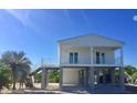Two-story home with a white exterior and balcony at 2445 Tamworth Ter, Punta Gorda, FL 33983