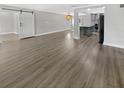 Open living space with hardwood floors and a view of the kitchen at 4104 W Gray St, Tampa, FL 33609