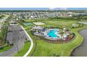 Community pool, playground, and parking area with homes in the background at 16107 Culpepper Dr, Bradenton, FL 34211