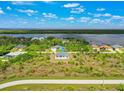 Aerial view of single-story home with water views at 9573 Shelburne Cir, Port Charlotte, FL 33981