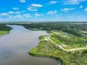 Aerial view of waterfront property and surrounding landscape at 9573 Shelburne Cir, Port Charlotte, FL 33981