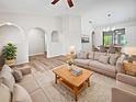 Bright living room featuring vaulted ceilings, modern furniture, and wood-look flooring at 3524 Cessna St, Port Charlotte, FL 33948