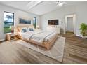 Bright main bedroom featuring a ceiling fan, a skylight, and wood-look flooring at 3524 Cessna St, Port Charlotte, FL 33948