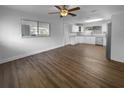 Bright kitchen features stainless appliances, white cabinets, granite counters, and wood floors at 4409 W Leila Ave, Tampa, FL 33616