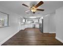 Bright kitchen features stainless appliances, white cabinets, granite counters, and wood floors at 4409 W Leila Ave, Tampa, FL 33616