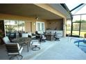 Outdoor patio with seating area and adjacent pool and kitchen at 4202 Perch Cir, Port Charlotte, FL 33948