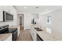 Modern kitchen with stainless steel appliances and granite countertops at 428 Lazy Shore Dr, Nokomis, FL 34275