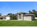 One-story house with a large front yard and attached garage at 1090 Yarmouth St, Port Charlotte, FL 33952