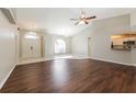 Bright living room with tile and wood flooring, high ceilings, and access to kitchen at 1090 Yarmouth St, Port Charlotte, FL 33952