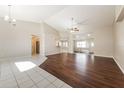 Open living area with high ceilings, wood floors, and sliding doors at 1090 Yarmouth St, Port Charlotte, FL 33952