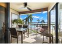 View from the balcony with a dining set, ceiling fan, and a nice view of the pool and waterway at 6268 Palma Del Mar S Blvd # 204, St Petersburg, FL 33715