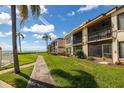 Condo exterior view showcasing manicured lawn and multiple balconies at 6268 Palma Del Mar S Blvd # 204, St Petersburg, FL 33715