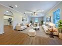 Bright and airy living room with hardwood floors and ample seating, perfect for entertaining guests at 3444 97Th E Ln, Palmetto, FL 34221