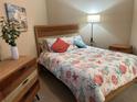 Comfortable bedroom with stylish decor and natural wood furniture at 23598 Awabuki Dr # 102, Venice, FL 34293