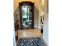 Welcoming foyer featuring tile floors, a display cabinet, and tasteful decor at 23598 Awabuki Dr # 102, Venice, FL 34293