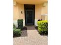 Inviting front entrance with a brick pathway and manicured bushes at 23598 Awabuki Dr # 102, Venice, FL 34293