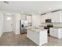 Bright, modern kitchen featuring stainless steel appliances, granite countertops, and a functional center island at 145 Lazy Shore Dr, Nokomis, FL 34275