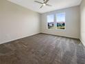 Spacious bedroom with neutral carpeting and large windows offering natural light at 12545 Ryegrass Loop, Parrish, FL 34219