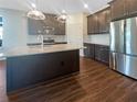Modern kitchen with granite countertops, stainless steel appliances, and dark wood cabinets at 12545 Ryegrass Loop, Parrish, FL 34219