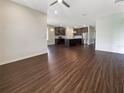 Open living room featuring wood-look flooring and kitchen view at 12545 Ryegrass Loop, Parrish, FL 34219
