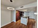 Open concept dining area with hardwood floors and kitchen access at 1208 E Kennedy Blvd # 1121, Tampa, FL 33602