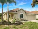 One-story house with tan exterior and landscaping at 11158 Golden Silence Dr, Riverview, FL 33579