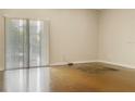 Empty living room with sliding glass doors and concrete floors at 1340 Apollo Beach S Blvd, Apollo Beach, FL 33572