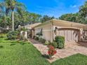 Single-story home with two-car garage and nicely landscaped yard at 5462 Chanteclaire # 65, Sarasota, FL 34235