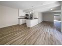 Open living area with wood-look tile floors and access to patio at 1052 Longfellow Cir, Sarasota, FL 34243