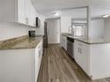 Bright kitchen with granite counters and stainless steel appliances at 1052 Longfellow Cir, Sarasota, FL 34243