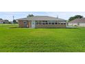 Back of house with large windows at 11343 Montcalm Rd, Spring Hill, FL 34608