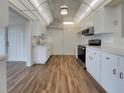Bright kitchen with white cabinets, stainless steel appliances, and wood-look floors at 8188 San Jacinto Ave, North Port, FL 34287