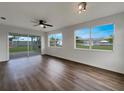 Bright living room with hardwood floors and sliding glass doors leading to backyard at 8188 San Jacinto Ave, North Port, FL 34287