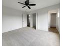 Spacious bedroom with carpet flooring, ceiling fan, and walk-in closet at 8188 San Jacinto Ave, North Port, FL 34287