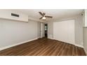 Bright bedroom with ceiling fan and wood-look flooring at 580 Leach St, Englewood, FL 34223