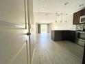 Bright living room with view of kitchen and sliding doors to patio at 1860 Massachusetts Ne Ave # 214, St Petersburg, FL 33703