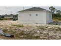 Rear view of the house showcasing its simple design at 13 Polar Ct, Placida, FL 33946
