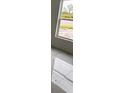 Bright bedroom with large window and marble-look tile floor at 63 Coxswaine Cir, Placida, FL 33946