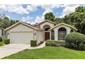 One-story home featuring a two-car garage and neatly landscaped yard at 533 Bent Oak Ct, Spring Hill, FL 34609