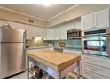 Stainless steel appliances and white shaker cabinets in this well-lit kitchen at 2340 Grecian Way # 46, Clearwater, FL 33763