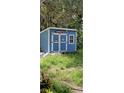 Blue storage shed with double doors and a Chevy sign at 7804 Chasco St, Port Richey, FL 34668