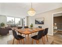 Dining area with modern chandelier, wood table, and view of living space at 6219 Palma Del Mar S Blvd # 301, St Petersburg, FL 33715